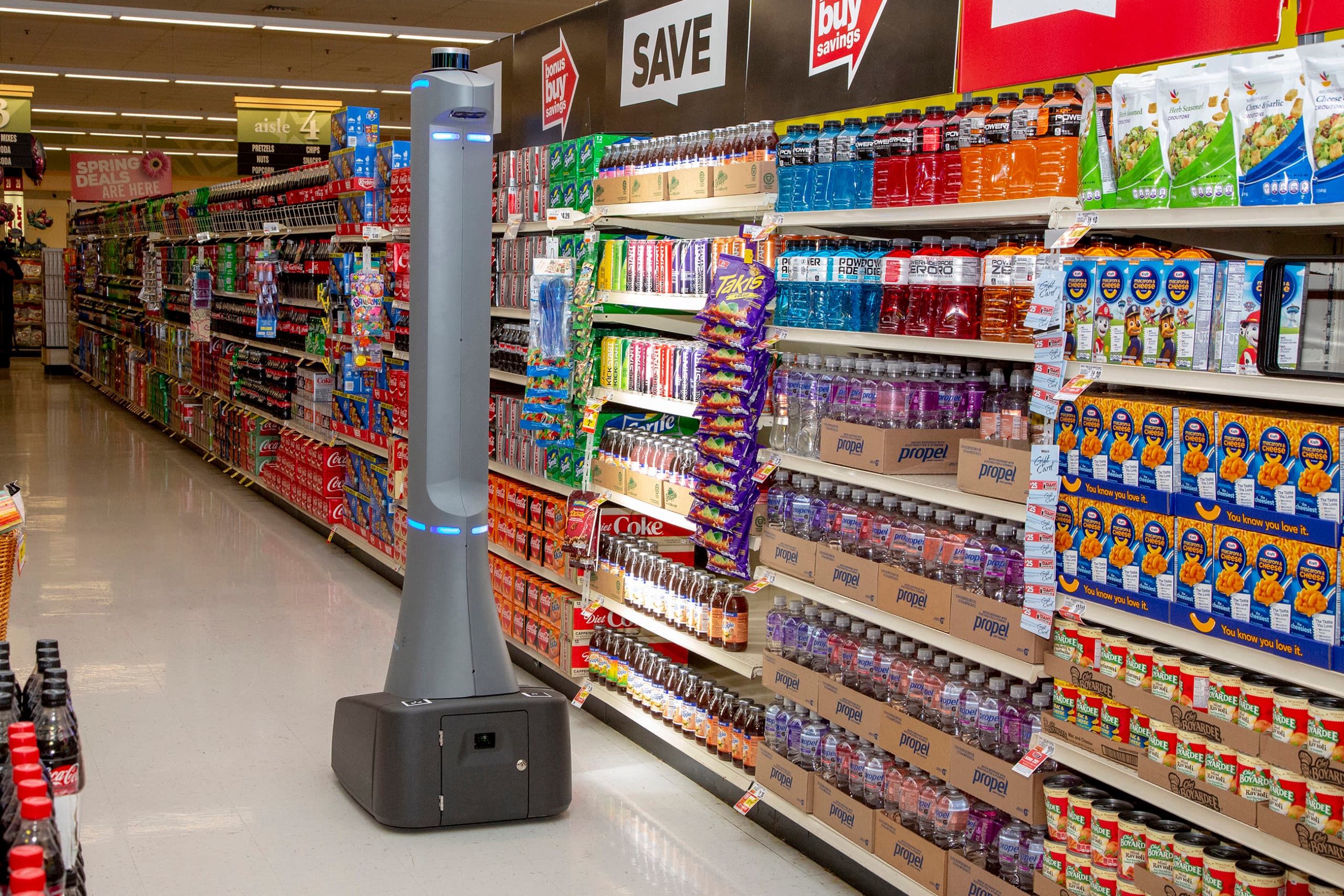 An autonomous robot scanning shelves in a grocery aisle